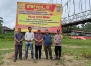 Polsek Kuantan Tengah Lakukan Sosialisasi dan Pemasangan Spanduk Larangan PETI di Desa Seberang Taluk